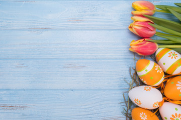 Easter eggs with Tulips on wooden background