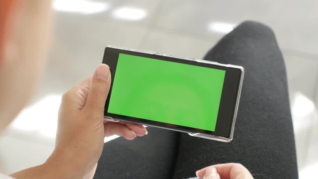 Female with green screen tablet at home 4K 2160p 30fps UltraHD footage - Woman holds greenscreen smart phone 3840X2160 UHD video 