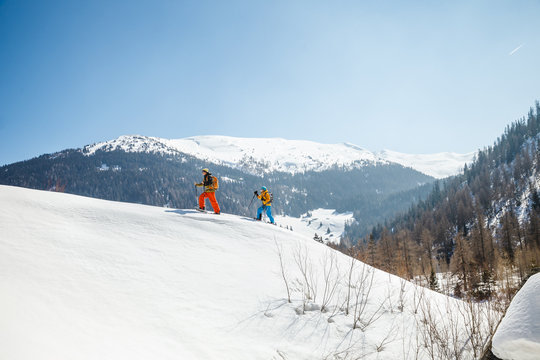 Two people snowshoeing in Alpine scenery