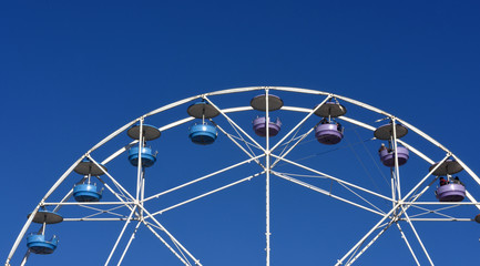 A Ferris wheel in a blue sky