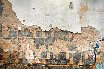 Texture in an abandoned building. Brick, peeling paint, sand