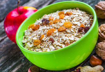 Oatmeal or oat flakes on dark wooden table
