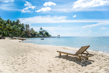 Fototapeta na wymiar Simple chair and beach scene with blue sky
