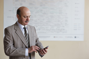 Man in suit talking on the phone, solving important questions.