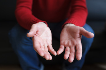 White male hands as if holding something.