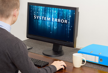 man working on computer with error