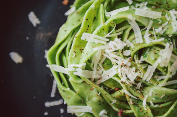 delicacy green pasta with homemade spinach and broccoli under a parmesan cheese and sesame seeds