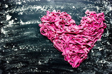 Fresh homemade beet pasta tagliatelle shaped heart