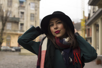 Attractive woman in hat and coat at the street in Lviv