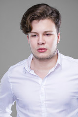 Fototapeta premium Elegant young handsome man in white shirt