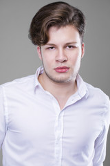 Obraz premium Elegant young handsome man in white shirt