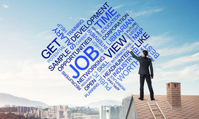 Young businessman standing on house roof and writing leadership 
