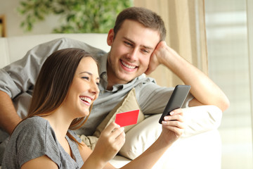 Happy couple buying online with credit card
