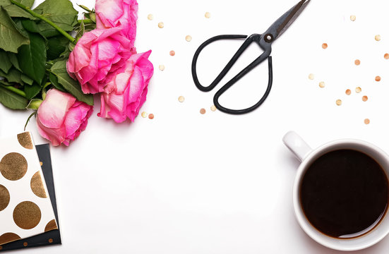 Pink roses, coffee and other things on white background