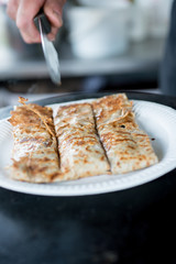 Crepe in Paper Plate Sliced into Three with Knife