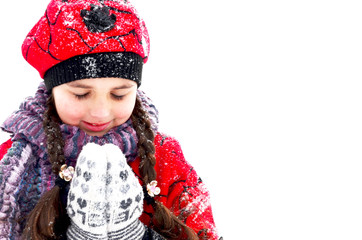 small girl playing with snow in winter weather