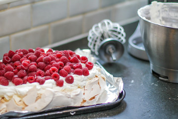Fresh Raspberry Meringue on the table with the whisk alongside