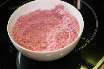 Pink mixture in the bowl on the glass table