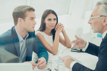 Three businesspeople sitting at office and having business meeti