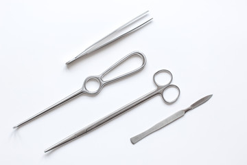 instruments for plastic surgery on white background top view