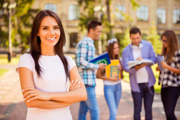 happy successful pretty  woman crossing hands and smiling near c