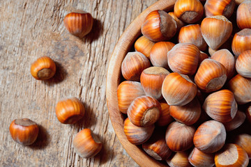 Hazelnut. Fresh organic filbert in wooden plate on wood backgrou