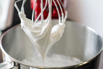 Big mixing Whisk full of white cream