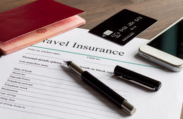 concept booking travel insurance on wooden background