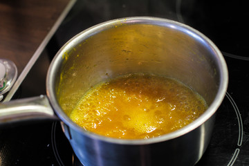 Yellow sauce in the metal sause pan  boiling