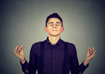 Young man meditating with eyes closed