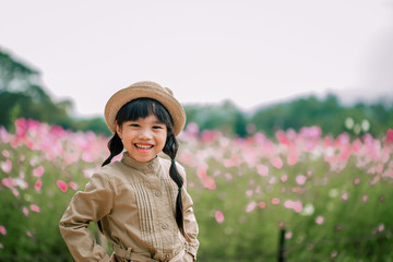 Beautiful child  flower in sumer park. Happy kid having fun outdoors.