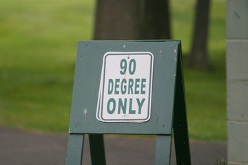 A 90-degree-only sign is positioned at a local public golf course due to recent rainfall