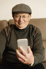 Senior man using his mobile phone.