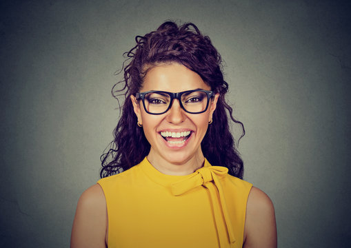 Laughing woman in yellow dress and glasses