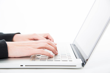 Closeup woman typing on laptop computer