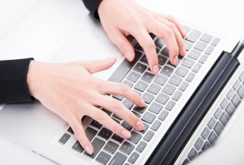 Fototapeta na wymiar Closeup woman typing on laptop computer