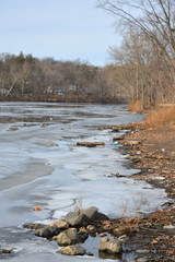 Partially frozen river with rocks