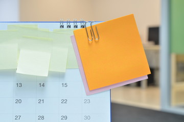 Paper notes on calendar at business office with copy space for text,office supplies;