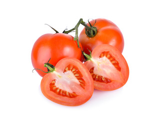 whole and half cut fresh tomato with stem on white background