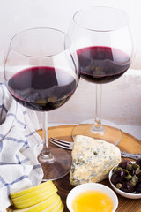 red wine and appetizers on a tray