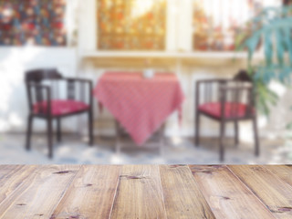 Perspective wood and blurred outdoor cafe background.