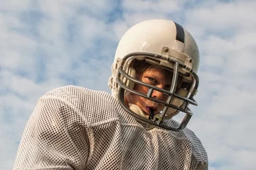 Fotobehang Young boy in football helmet © soupstock