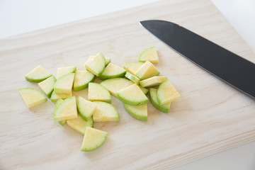 Diced zucchini, courgetti on a cutting board
