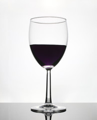 Tall wineglass with grape juice isolated on white background