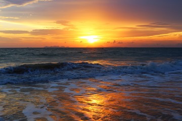 Beautiful sunset at the beach with sea waves