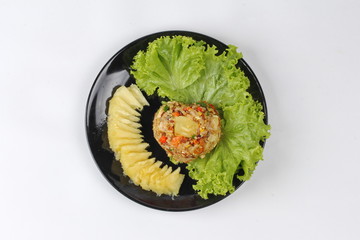 Fried brown rice with pineapple in yellow curry powder.