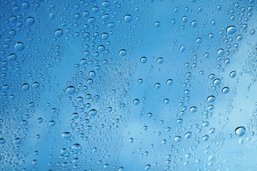 rain drop on glass background against blue sky
