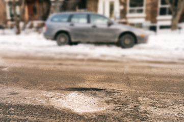 Fototapeta na wymiar Large deep pothole in Montreal street, Canada.