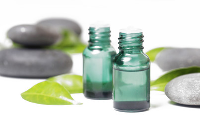 Green cosmetic bottles with zen stones 