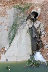 dirty water discharge flows into the river